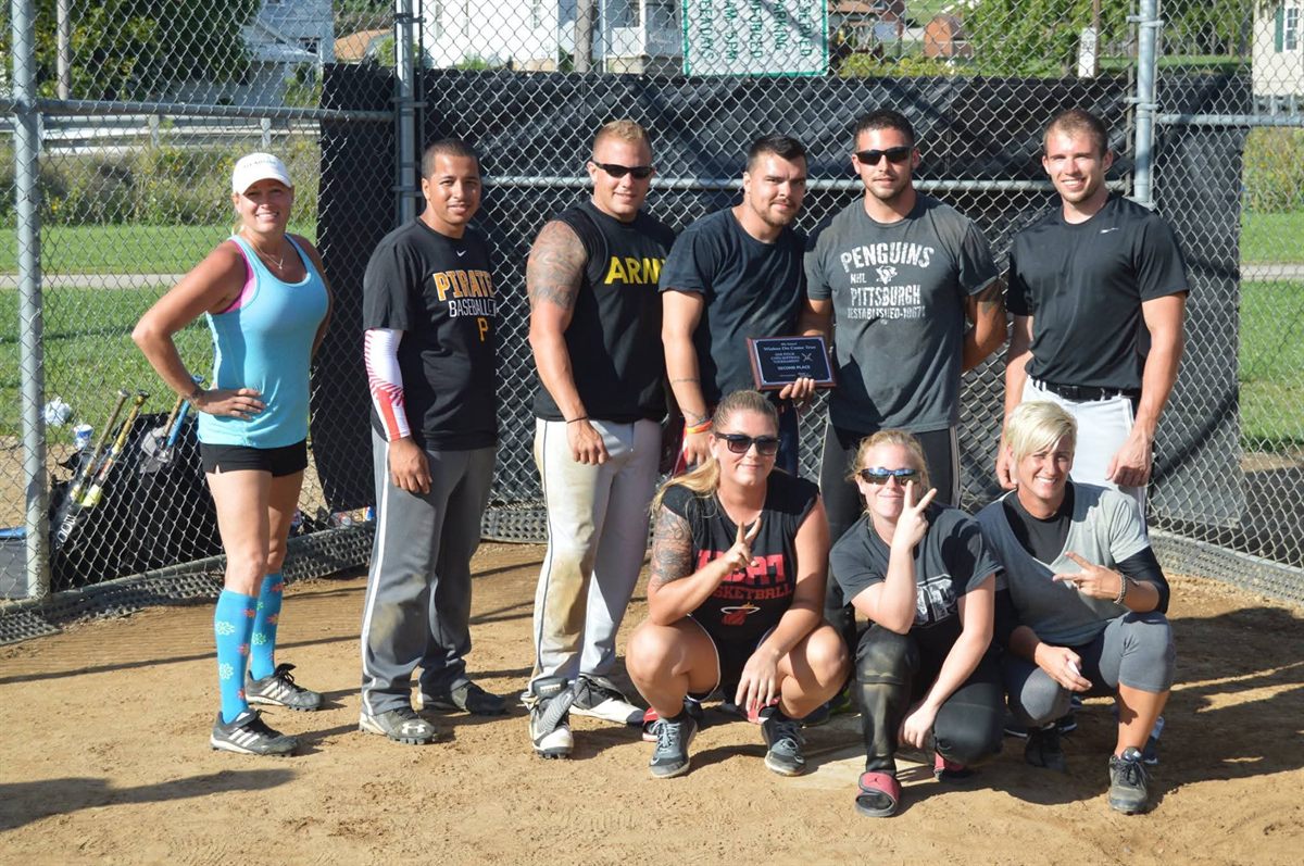 A team with their second-place plaque at the backstop