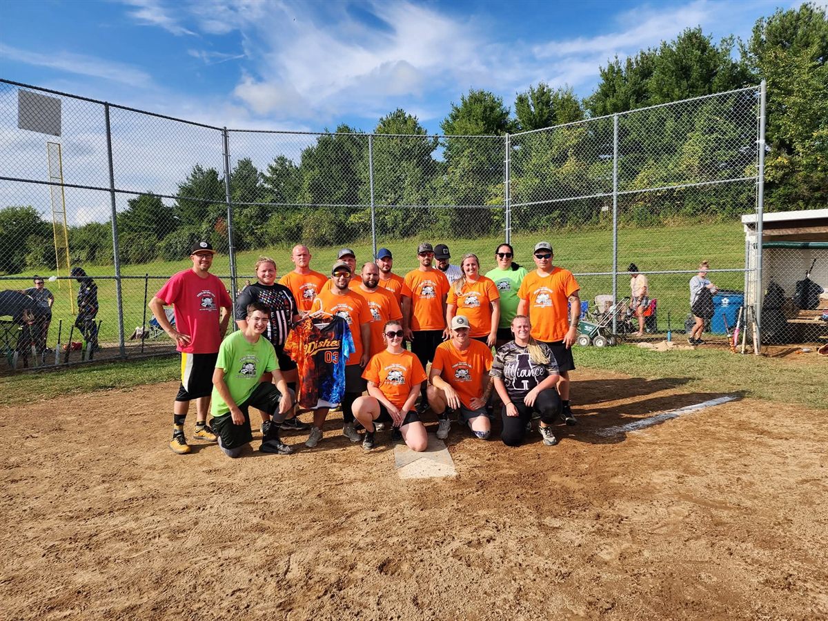 A team holding up a custom Wishes flame jersey