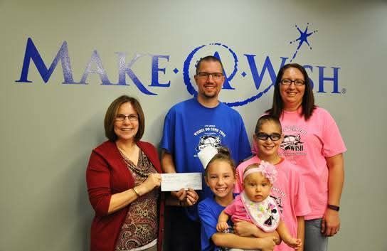 A check presentation at the Make-A-Wish office