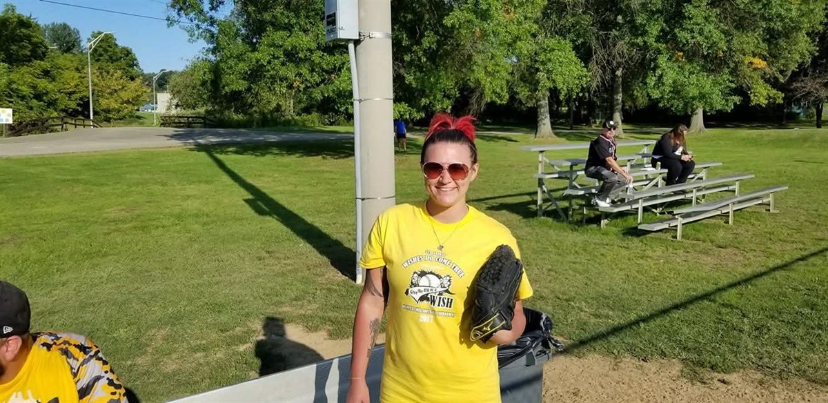 A player in a tournament shirt with her glove