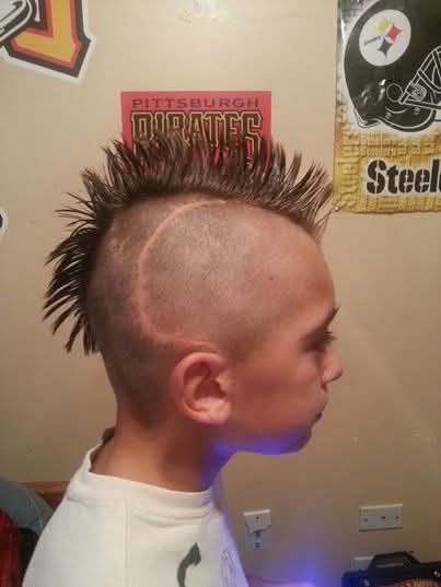 A kid showing off a fresh mohawk